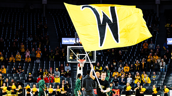 Person holding WSU Flag